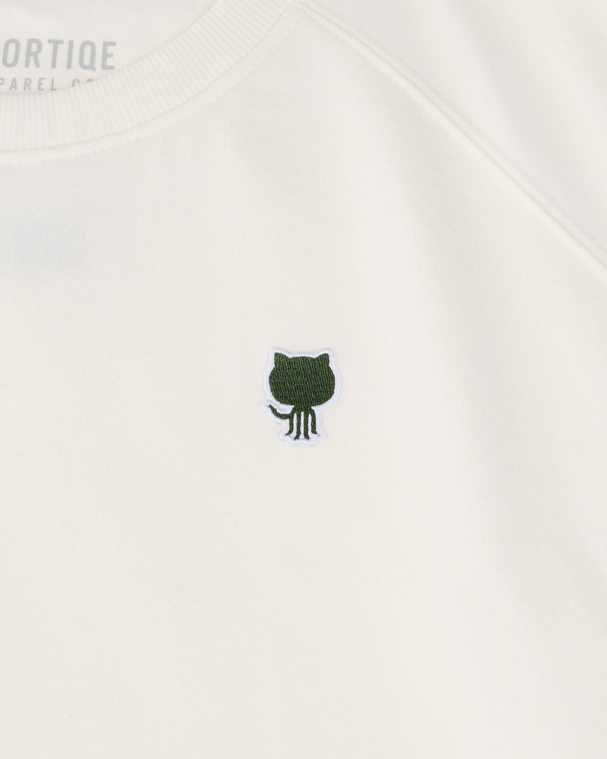 Close up of White cropped crewneck hoodie featuring the embroidered Octocat logo on the left chest