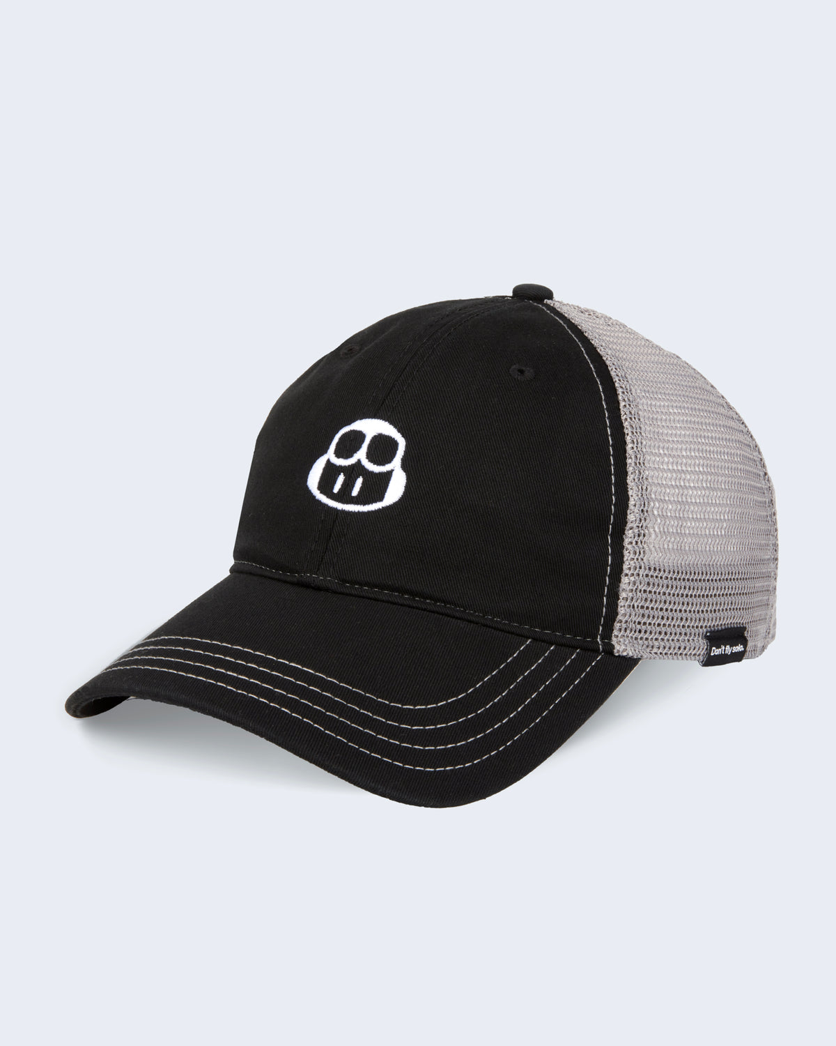 Angle view of trucker hat in black with gray mesh on the back featuring embroidered CoPilot logo in white at the front panel