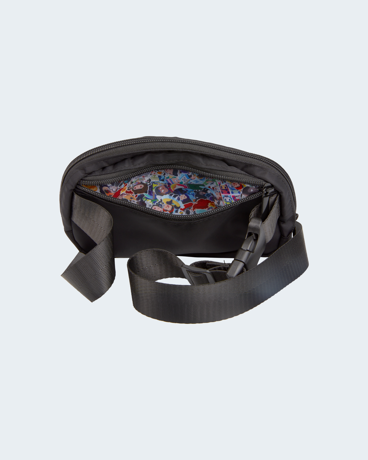 Inside view of belt bag in black showing organizer pockets and interior sticker collage lining.