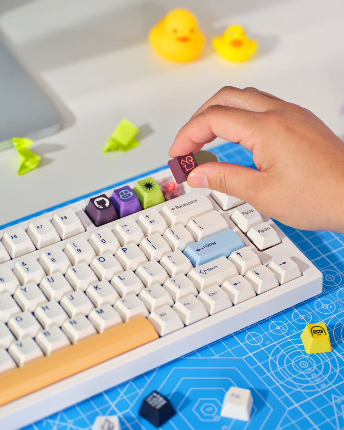 person installing GitHub key caps on mechanical keyboard.