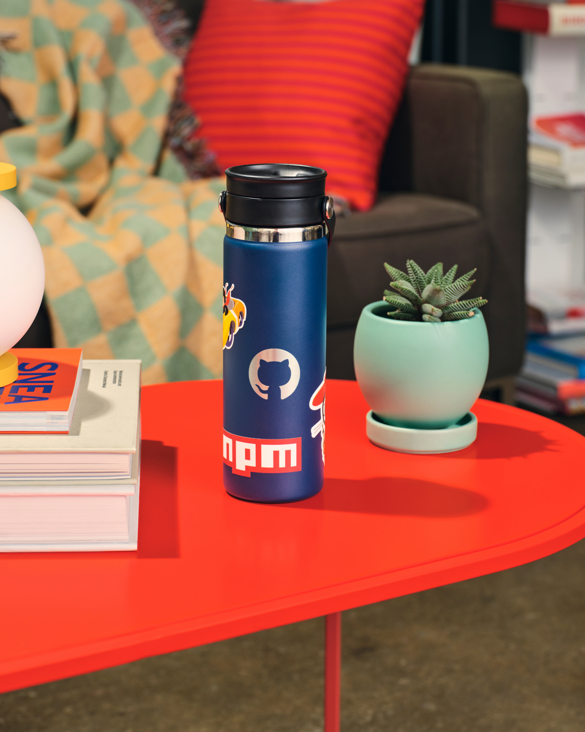 Invertocat Hydroflask Waterbottle on a living room coffee table.
