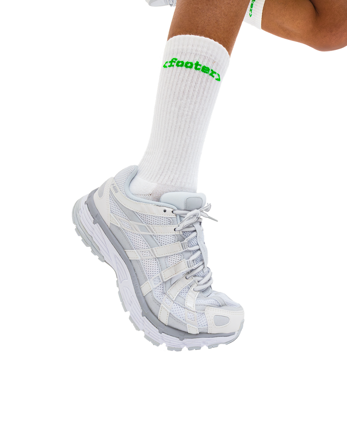 Model wearing the GitHub footer socks with white shoes