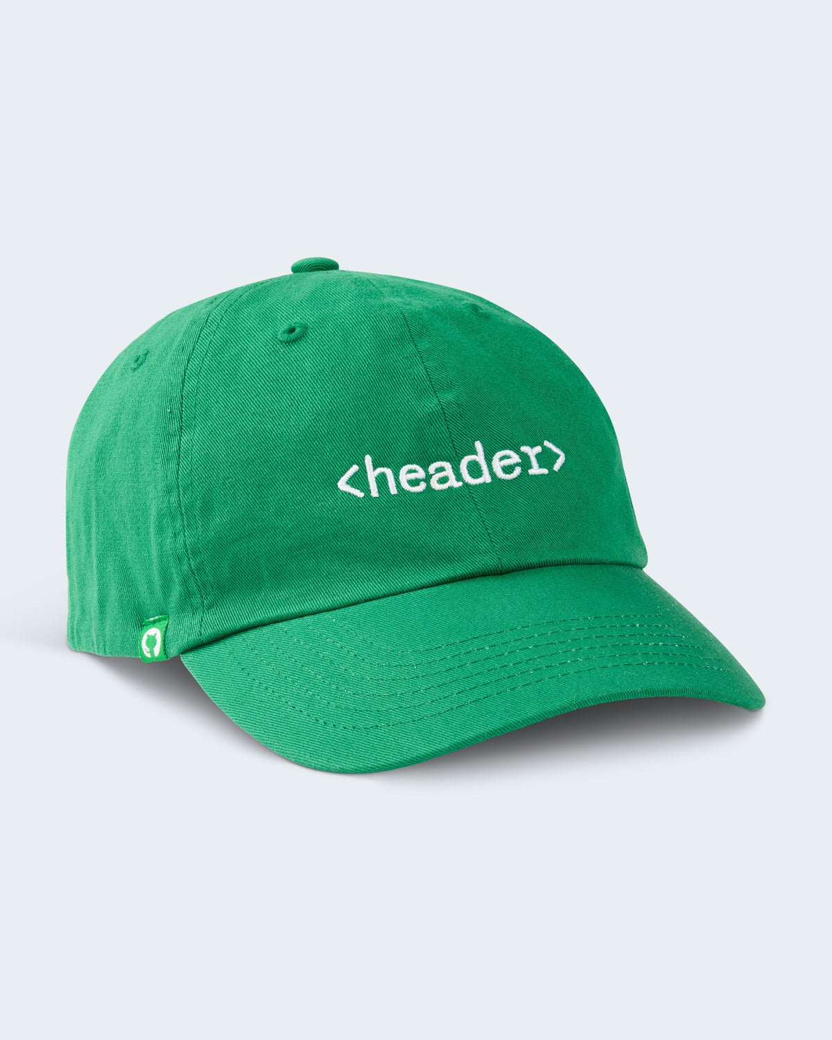 Angled view of green unstructured cap featuring embroidered '<header>' on front panel