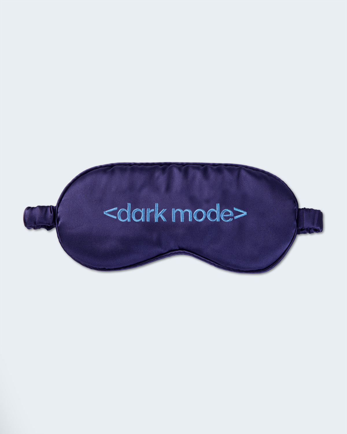 Dark purple sleep mask with "dark mode" embroidery.