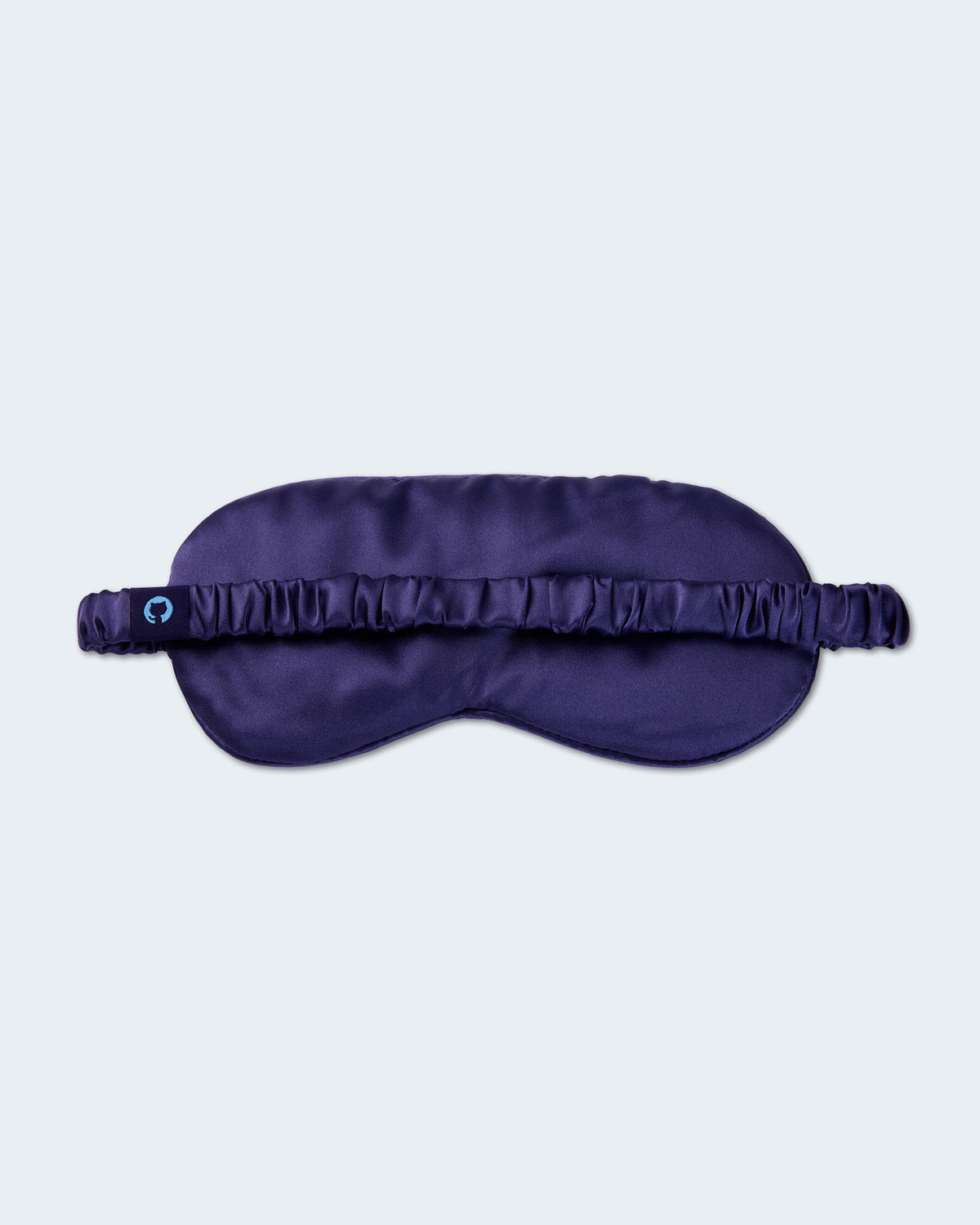 Dark purple sleep mask with elastic strap.