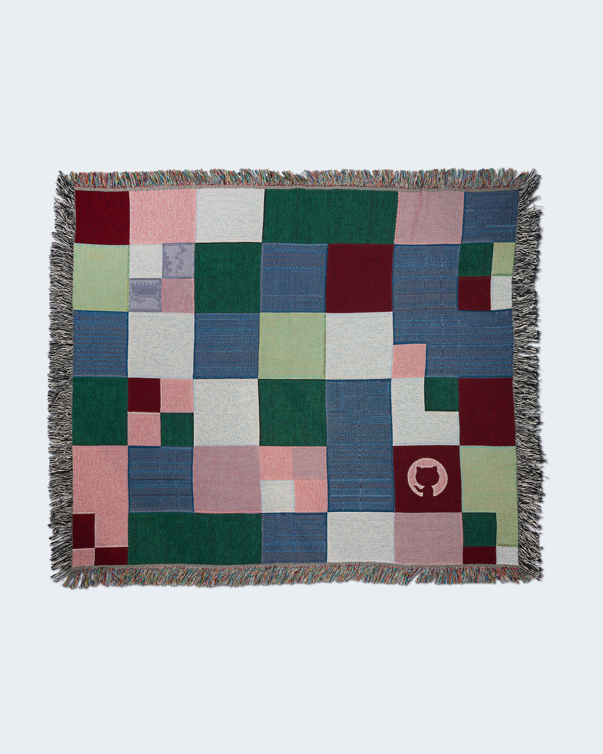 Multicolor patchwork woven throw blanket with fringe.