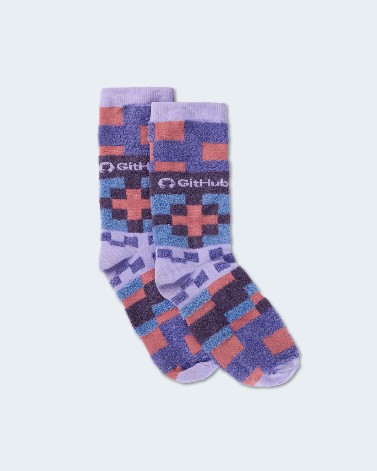 Lavender GitHub crew socks with a purple, blue, and coral pixel pattern.