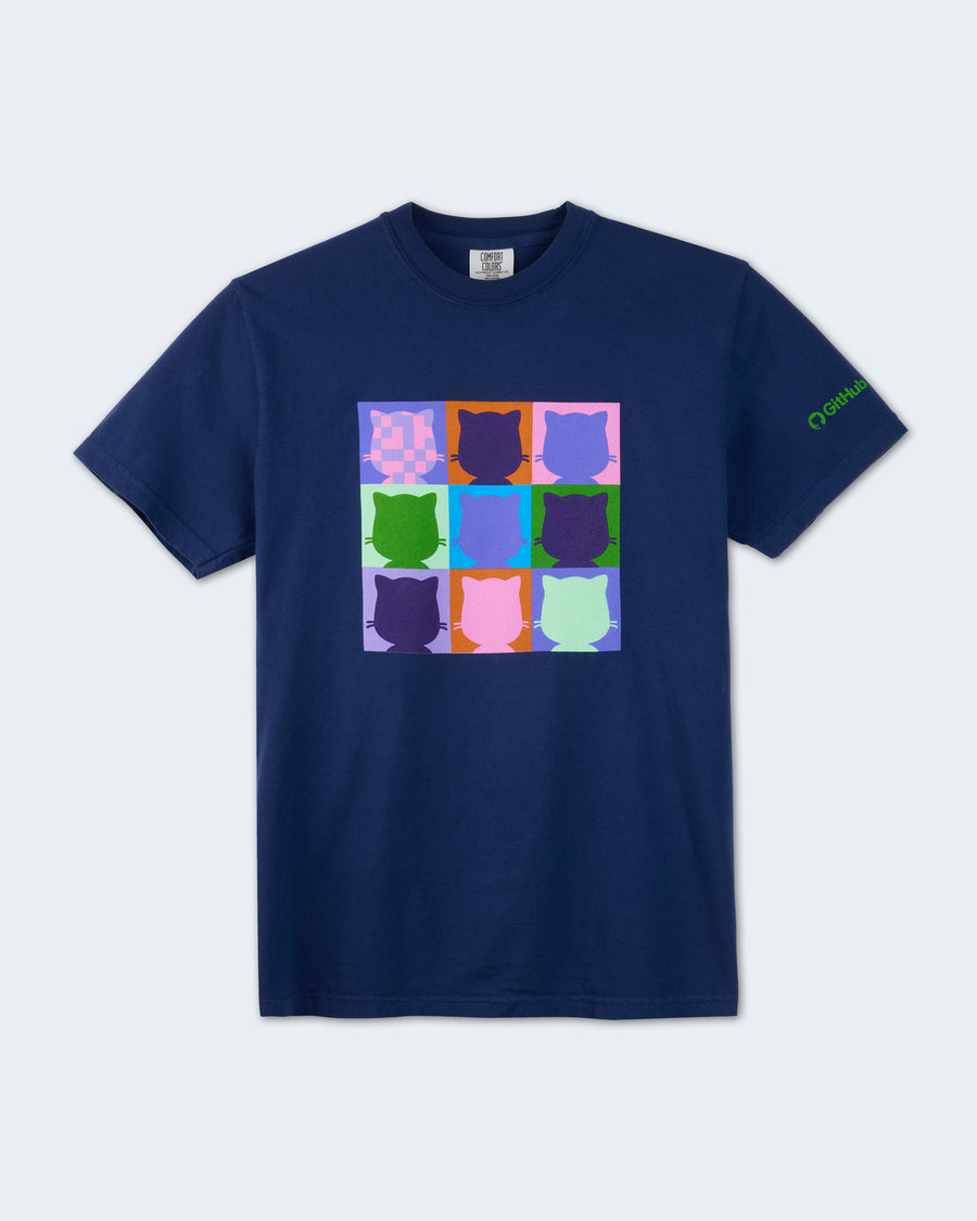 Navy blue short-sleeve t-shirt featuring a colorful nine-panel grid of Mona head silhouettes in assorted purple, blue, green, pink, and orange colors on the front chest. A small green GitHub logo graphic is printed on the left sleeve. #color:Navy