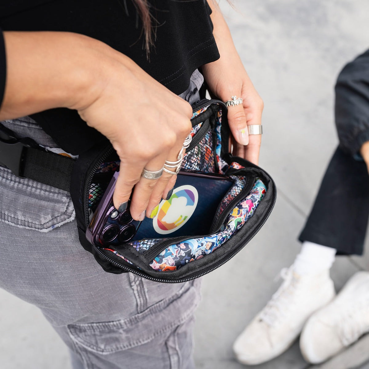 Photo of woman opening Sticker Collage Belt Bag