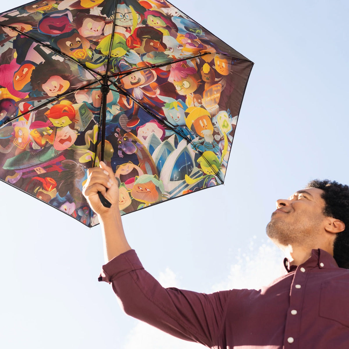 Photo of man holding Mona Collage Pocket Umbrella outdoors.