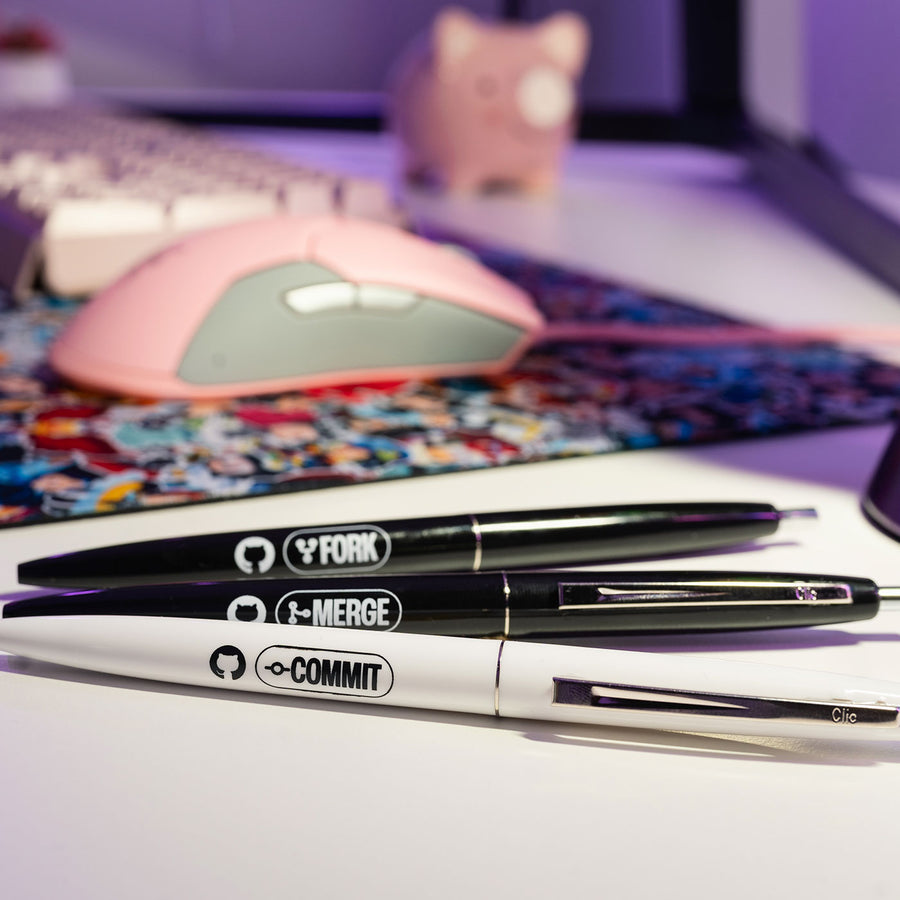 Photograph of the Commit, Fork, Merge Pen Set on a office desk.