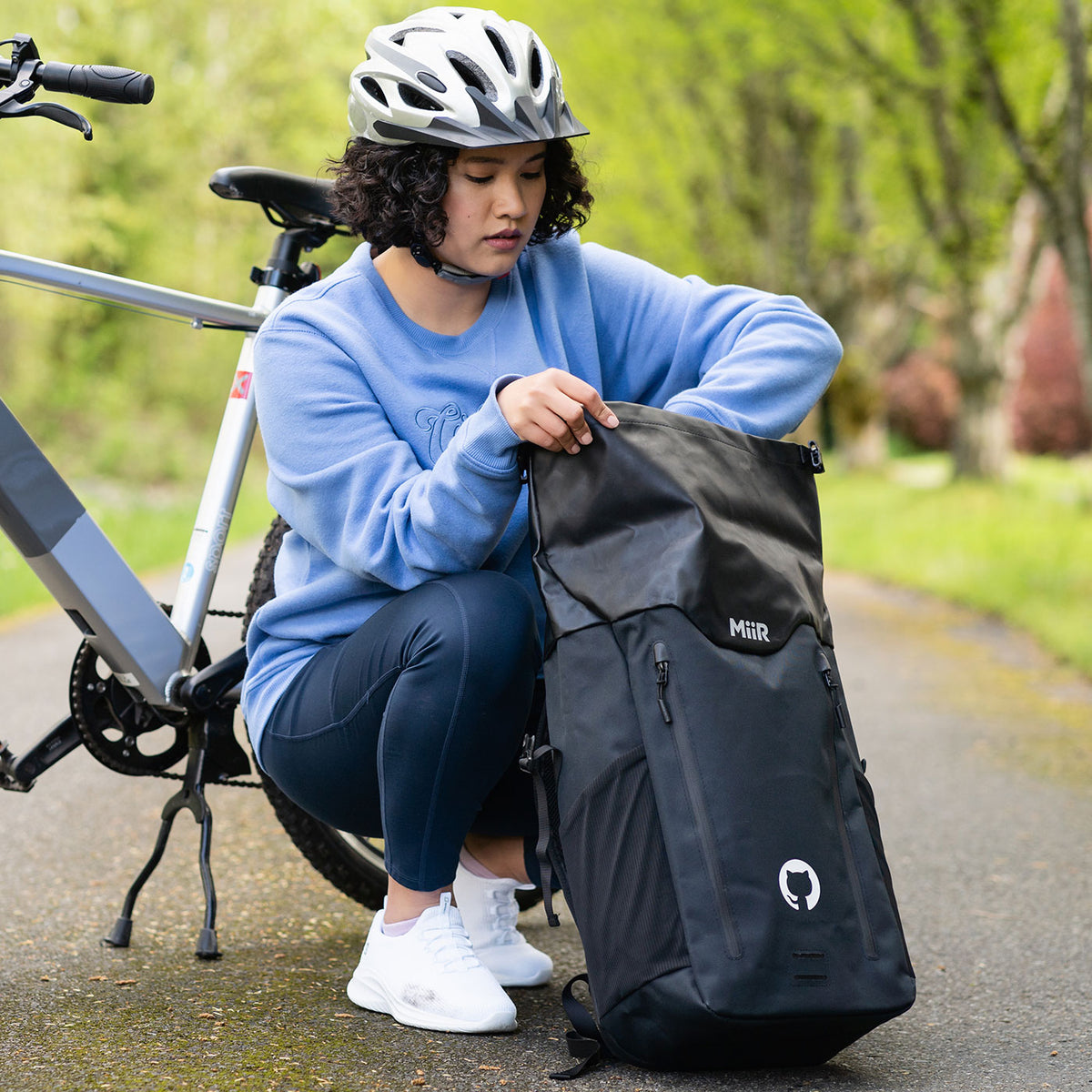 Photo of woman holding Miir Laptop backpack.