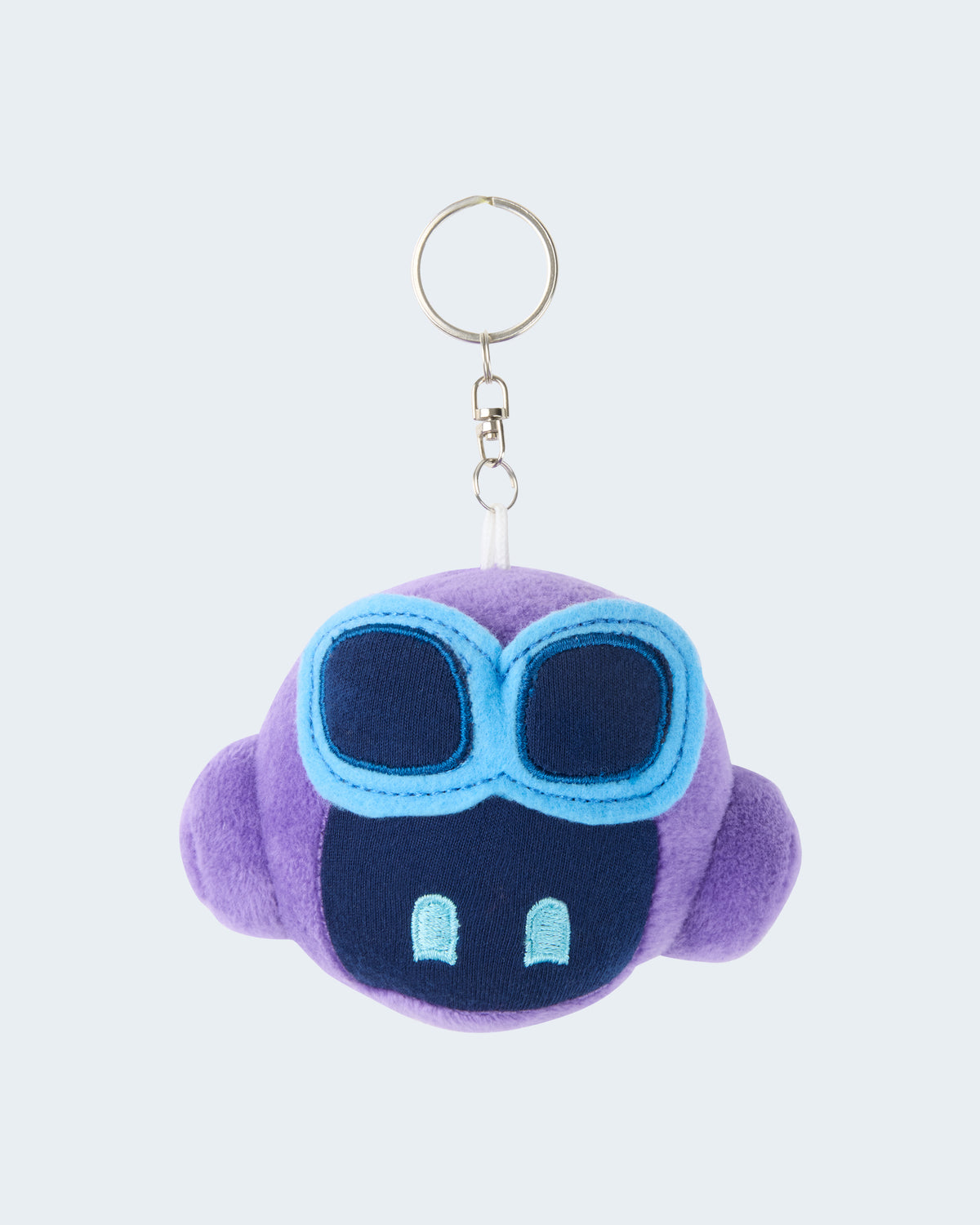 Purple GitHub Copilot plush keychain featuring a soft embroidered face with blue goggles, attached to a silver key ring