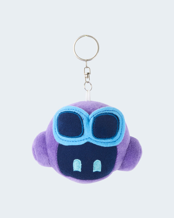 Purple GitHub Copilot plush keychain featuring a soft embroidered face with blue goggles, attached to a silver key ring