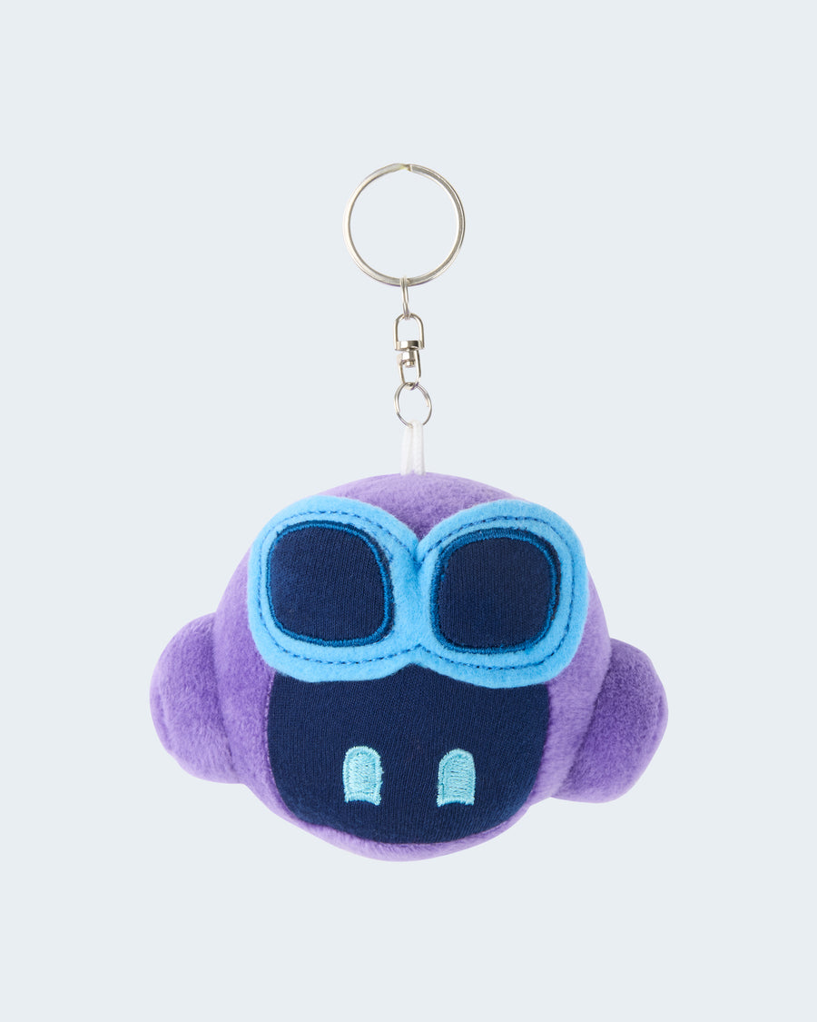 Purple GitHub Copilot plush keychain featuring a soft embroidered face with blue goggles, attached to a silver key ring