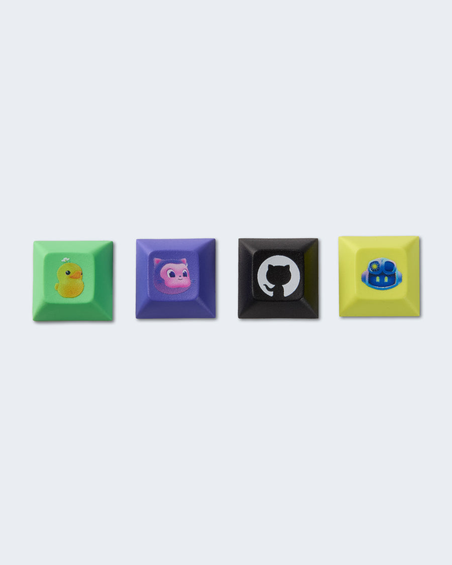 Set of four colorful keycaps - green, purple, black and yellow featuring GitHub characters.