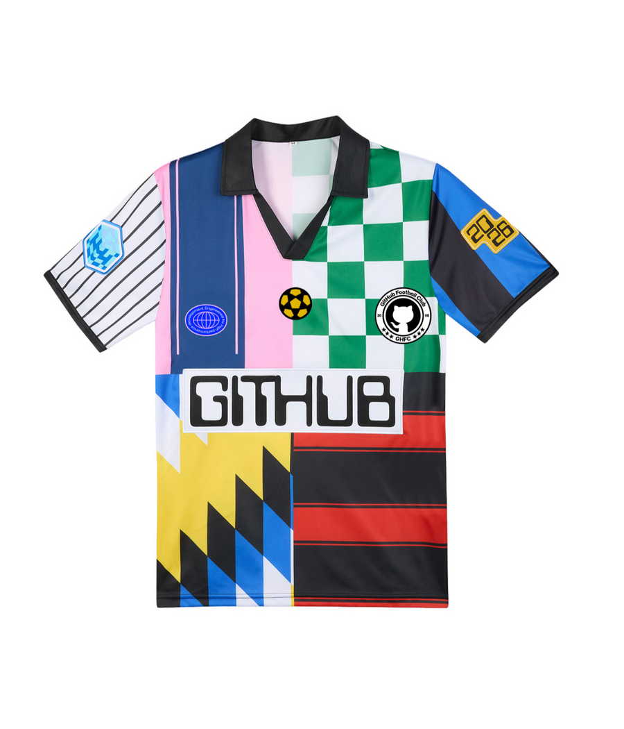 Colorful World Cup–inspired soccer jersey shirt with a black collar, featuring mixed patterns, patches, and a large "GITHUB" logo on the front.