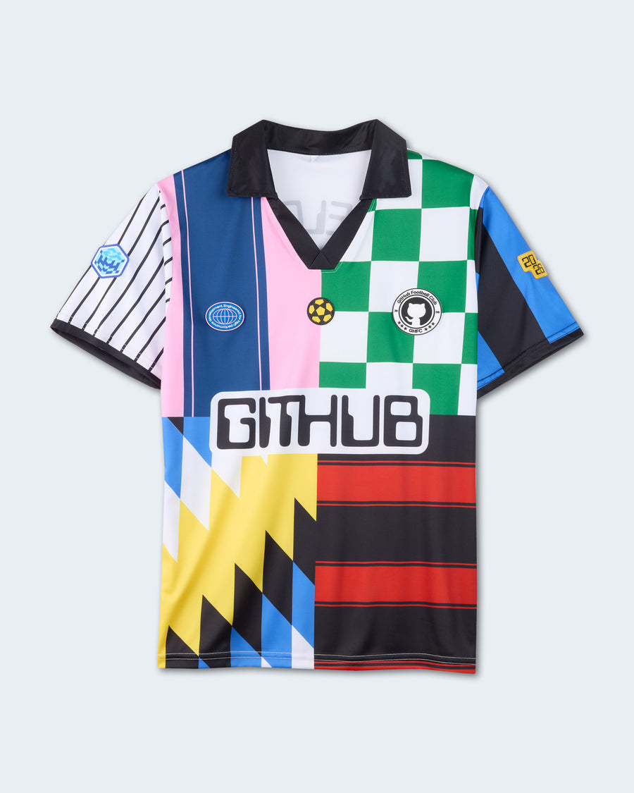 Colorful World Cup–inspired soccer jersey shirt with a black collar, featuring mixed patterns, patches, and a large "GITHUB" logo on the front.