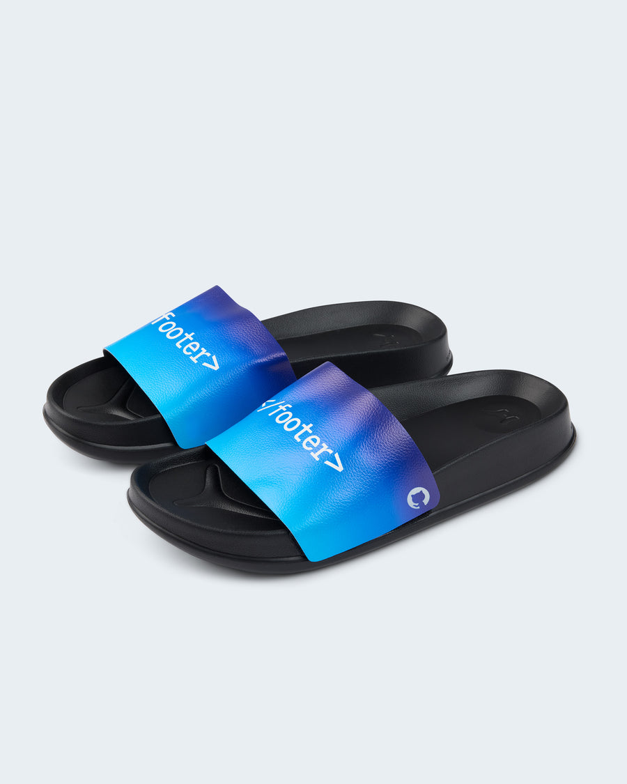 A pair of black slide sandals featuring a blue gradient strap that features the text <footer> in a white font and a small white GitHub logo on the side.