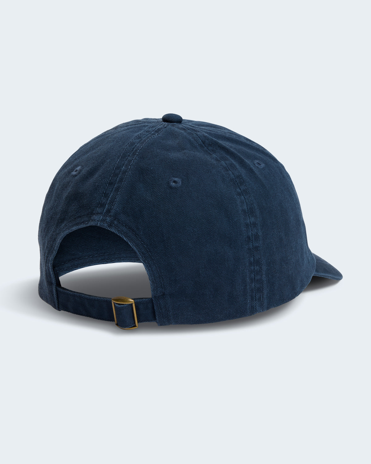 Back view of navy unstructured cap with fabric and brass glide buckle closure.