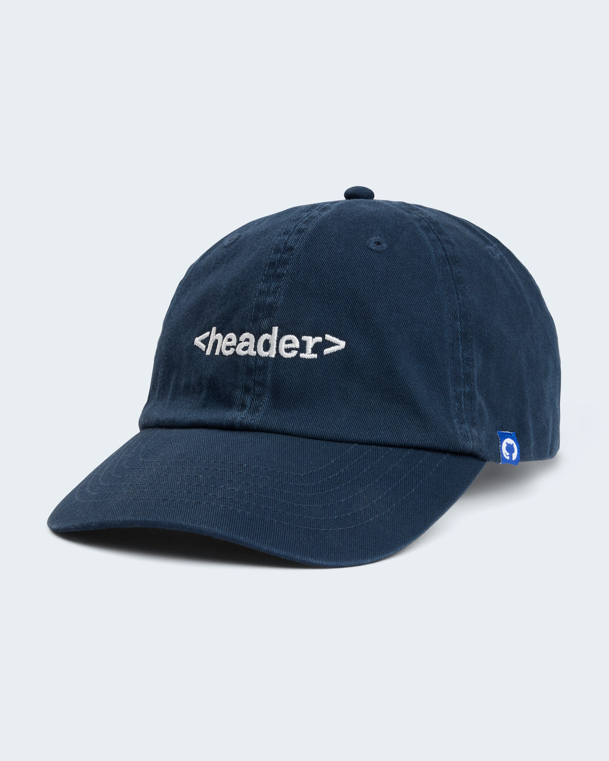 Angled view of navy unstructured cap featuring embroidered '<header>' on front panel