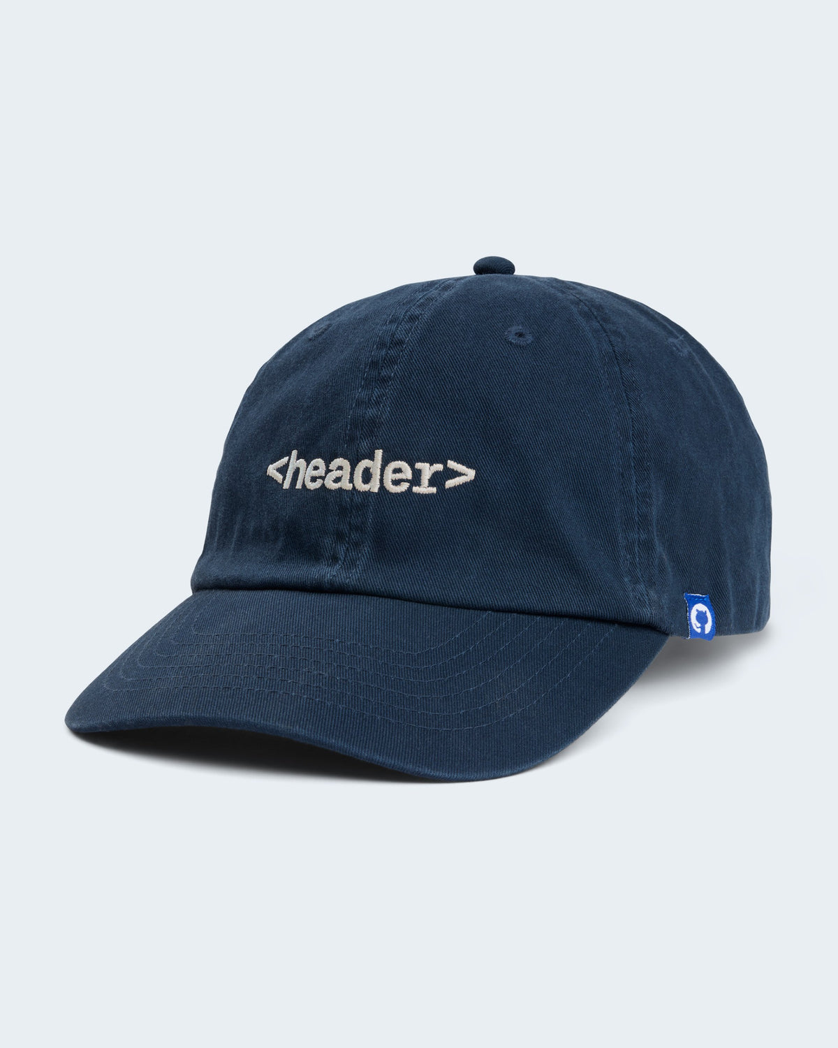 Angled view of navy unstructured cap featuring embroidered '<header>' on front panel