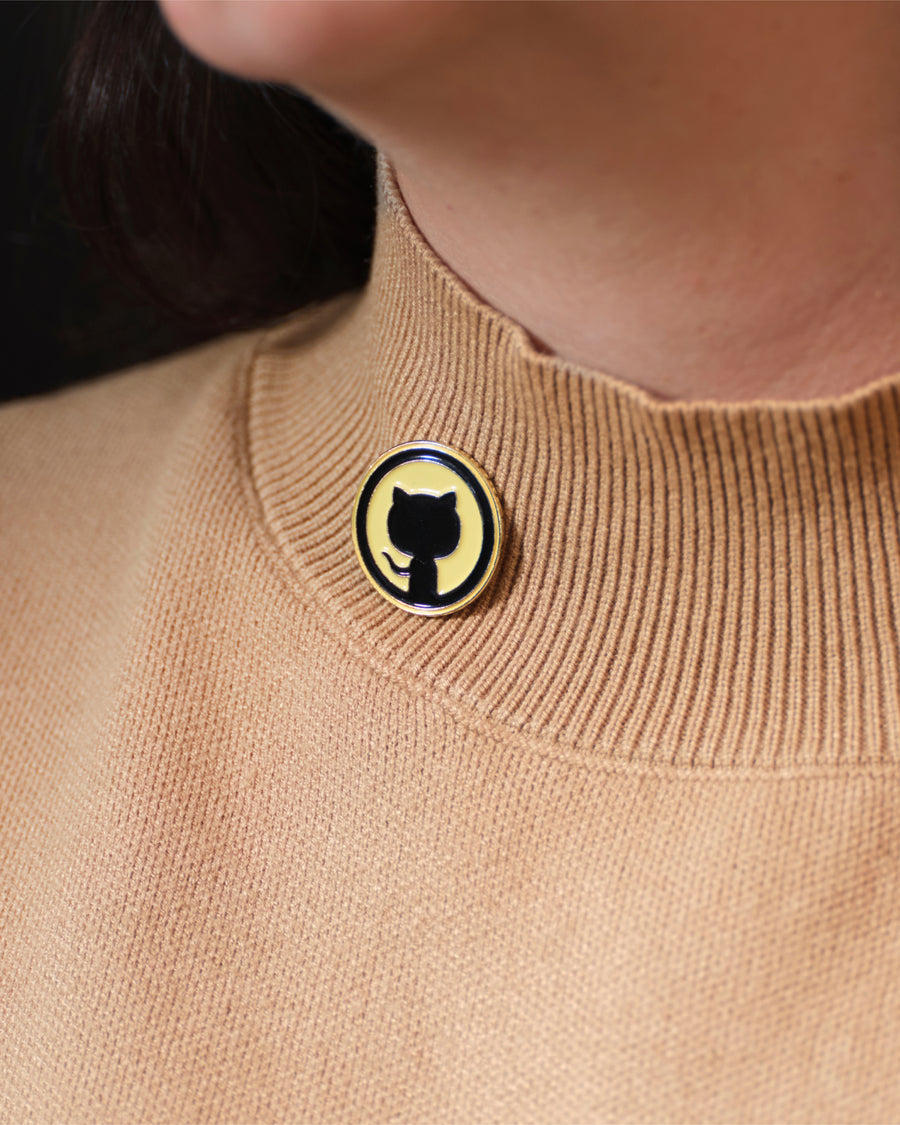 Photo of Invertocat Pin placed on woman's collar.