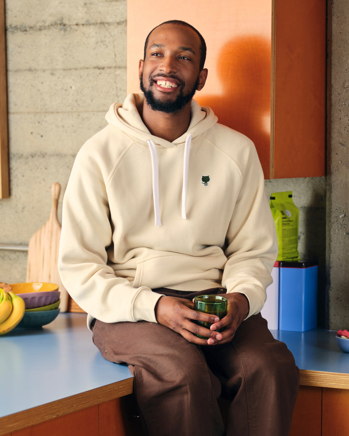 Photo of man in kitchen wearing Sportiqe Logo Patch Hoodie