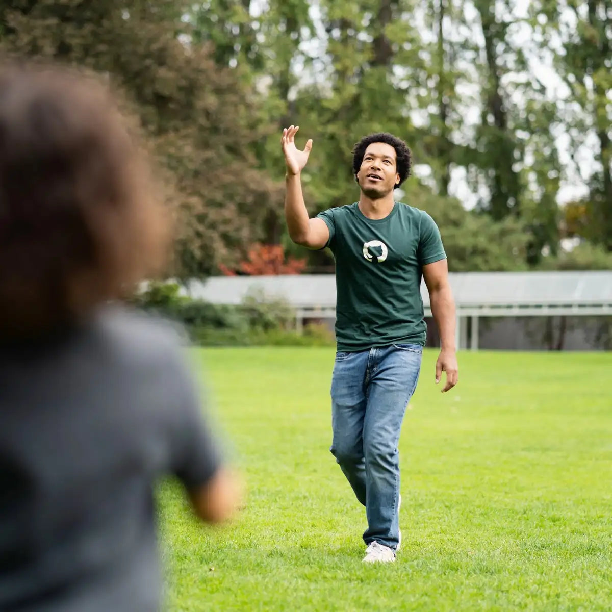 Photo of man at a park wearing Invertocat 4.0 Shirt in green